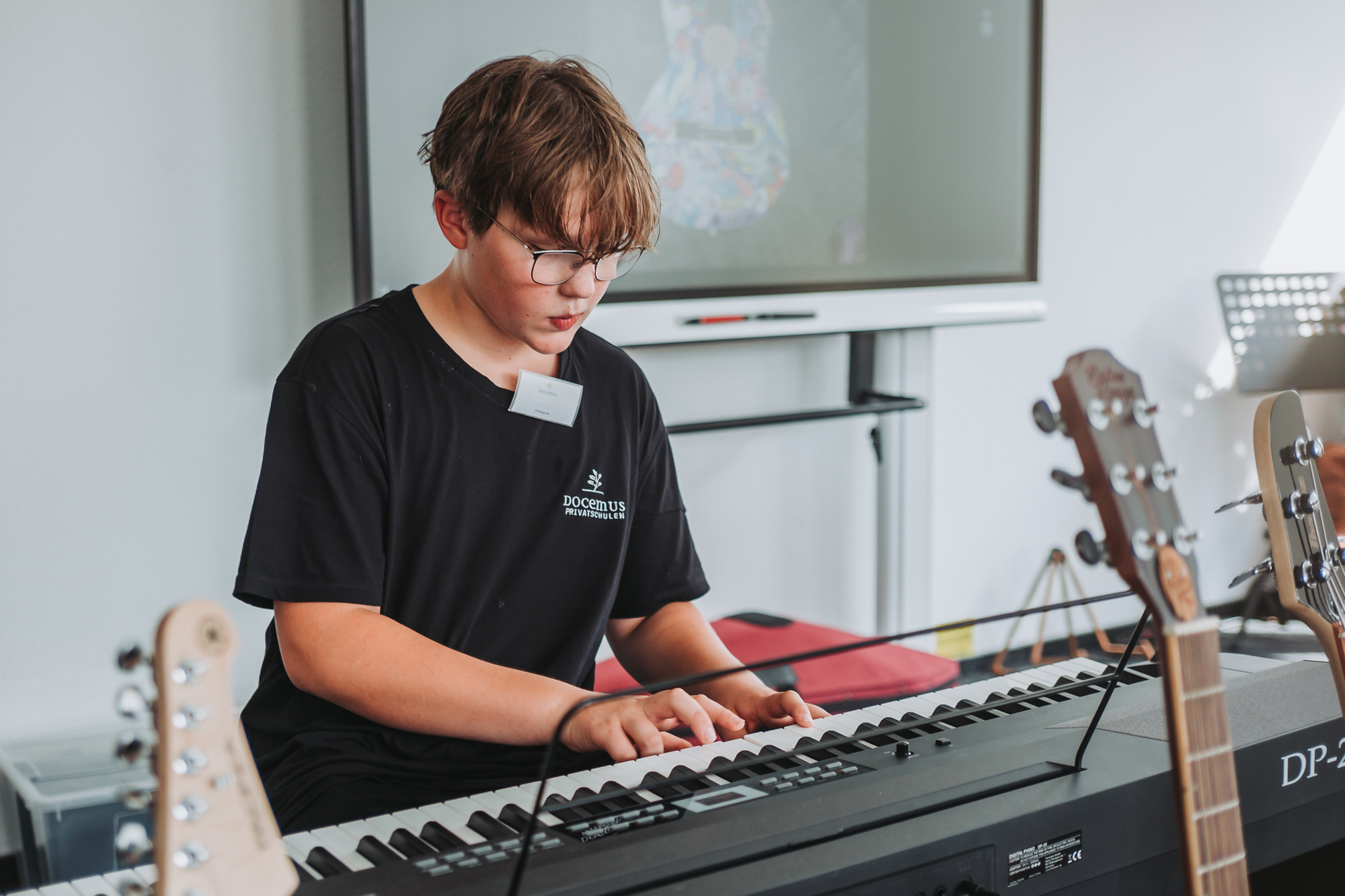 Schüler macht Musik im Musikzimmer mit bester technischer Ausstattung